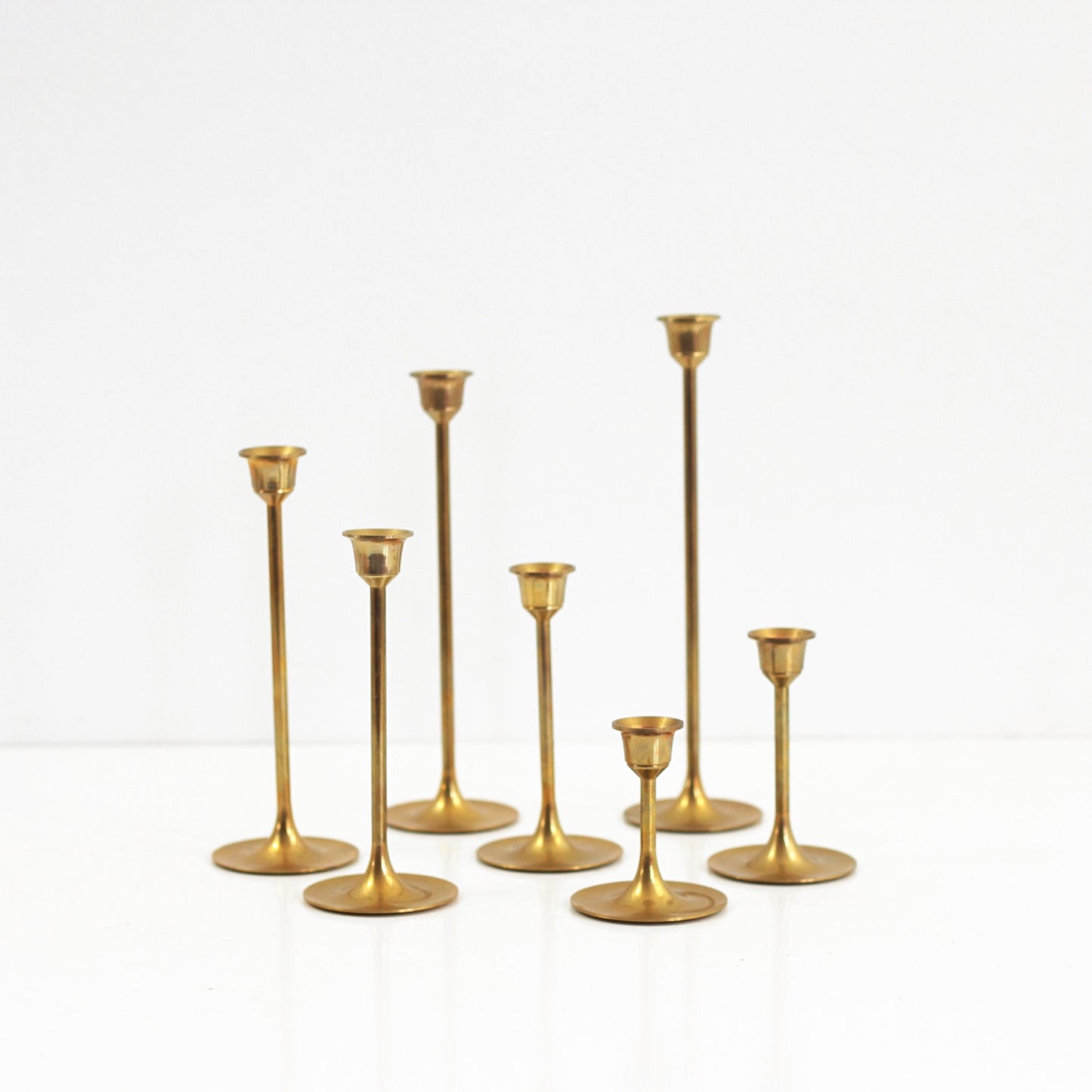 SOLD - Set of Seven Mid Century Modern Brass Candlesticks